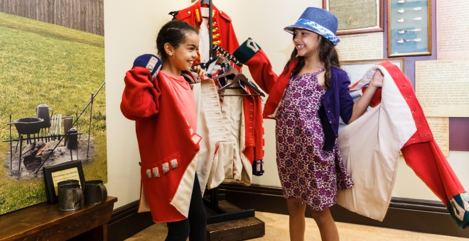Children playing dress-up in War of 1812 Uniforms